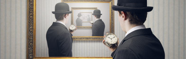Man in a bowler hat with a watch stands in front of a gold frame with repeated images of the same man receding into the distance.